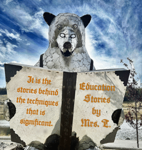 A large bear is reading a book entitled, Education Stories.