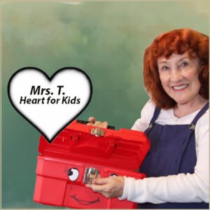 This is Penelope, known to many as Mrs. T holding a red tool box with only a heart in it.