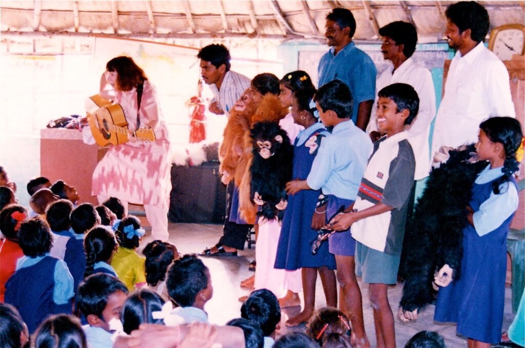 Penelope is entertaining the kids of a tribal village on her teaching tour.