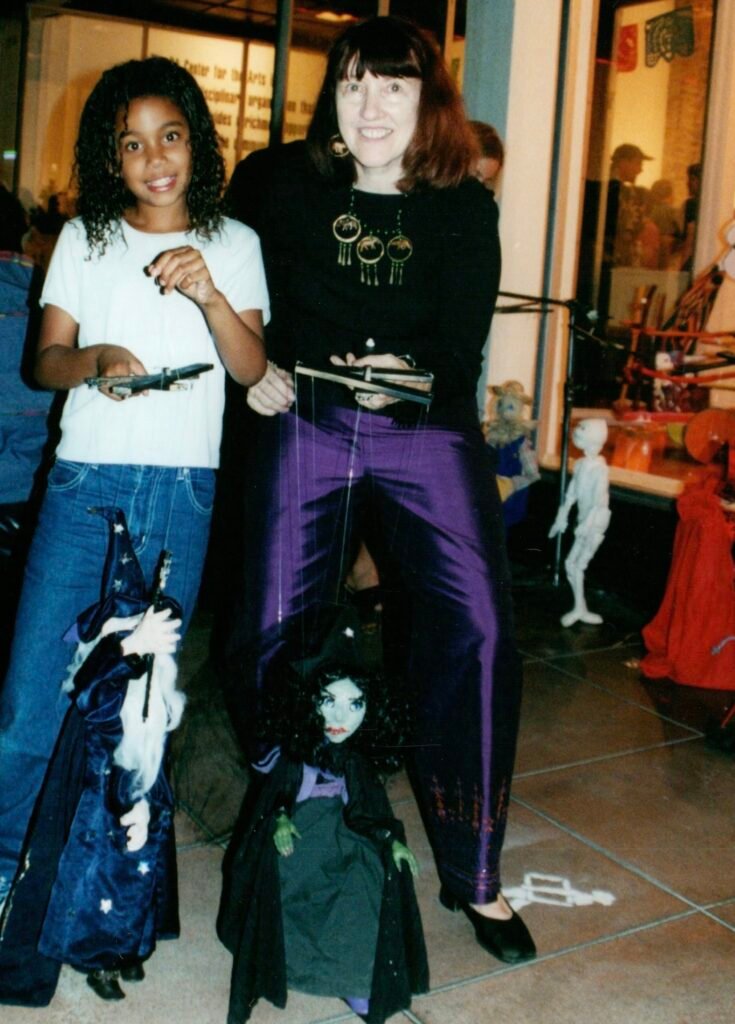 Girl using marionette at a festival